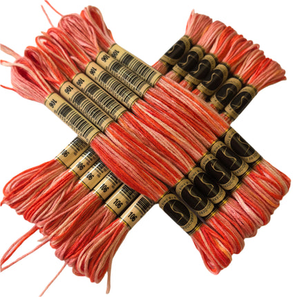 Set of pink embroidery threads with labels on a light background