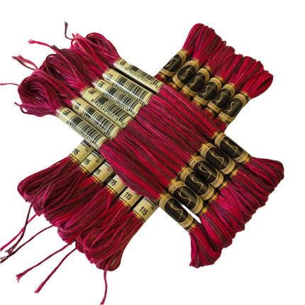 Red embroidery threads with labels on a beige fabric background