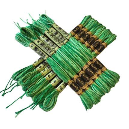 Bundles of green embroidery floss with labels on a white background