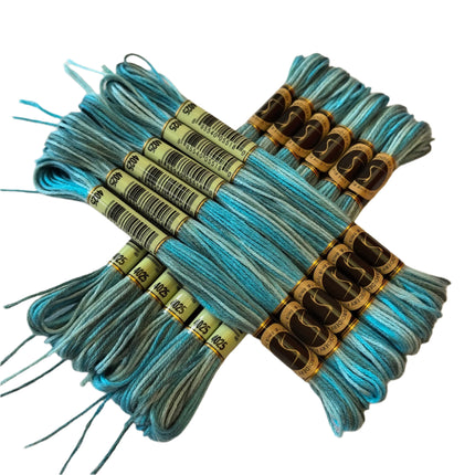 Bundles of blue embroidery floss with labels on a beige background