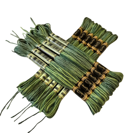 Green embroidery floss bundles with labels on a beige background
