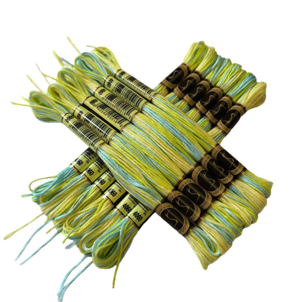 Set of green and blue embroidery threads with labels on a beige background