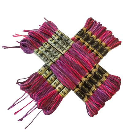 Bundles of pink and purple embroidery thread with labels on a white background