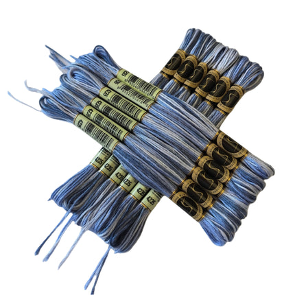 Bundles of blue embroidery floss with labels on a light beige background
