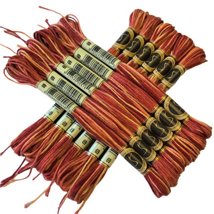 Bundles of red embroidery floss with brand labels on a white background