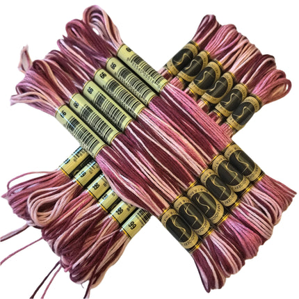 Bundles of pink embroidery floss with labels on a light background